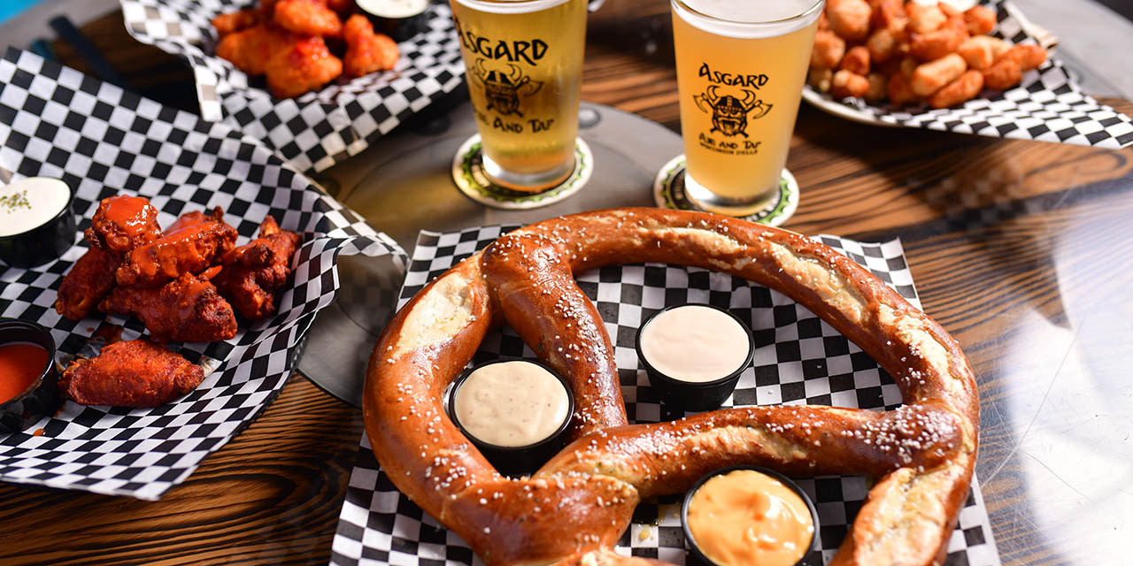 Pub food served including large pretzel and wings.